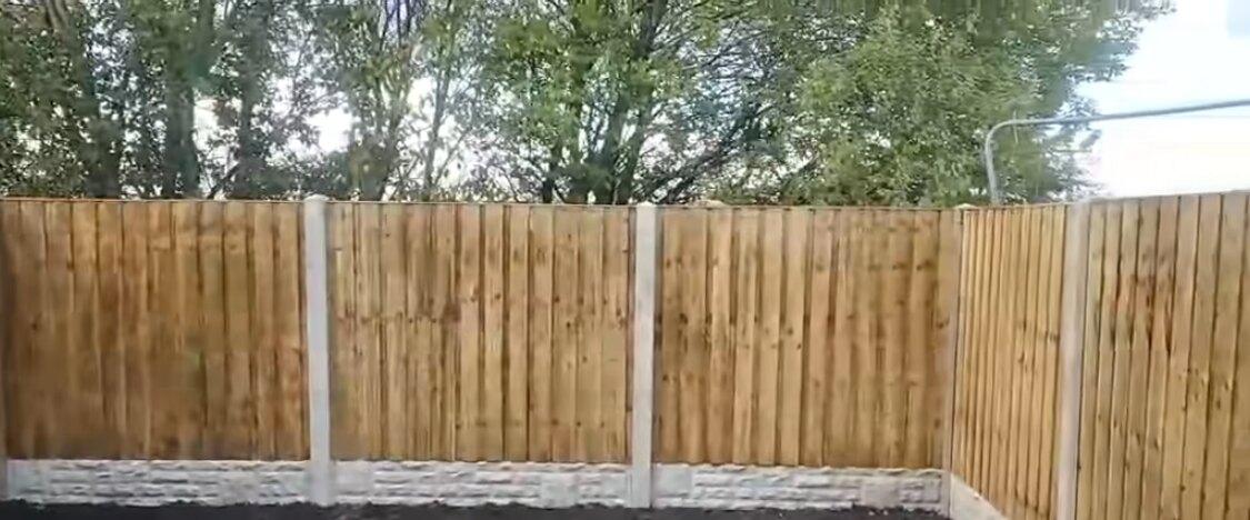 A newly enclosed rear garden with closeboard fencing on three sides above freshly turned soil
